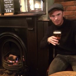 Mitch the younger bro enjoying a brew by the fire