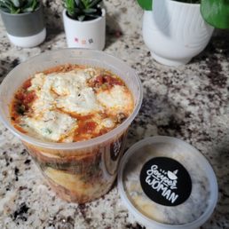 a bowl of soup and a container of soup a bowl of soup and a container of soup