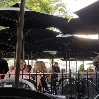 Wild River Grille - Umbrella's over outside seating - New American Near Me - Reno, Nevada