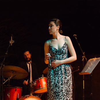 Paula Marengo Ensemble - a woman in a dress and a man in a suit - Jazz & Blues Near Me Paula Marengo Ensemble - a woman in a dress and a man in a suit - Jazz & Blues Near Me