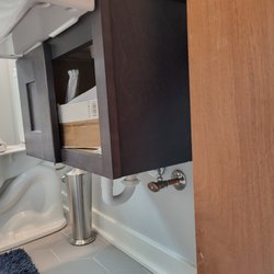 F+S Kitchen and Bath Design Studio - Cabinet was supposed to cover new pipes; left unfinished.