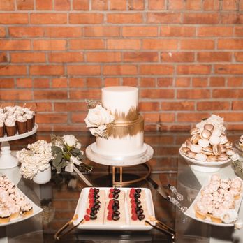 Heritage & Co - a dessert table with a cake and cupcakes - Desserts Near Me