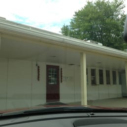 the front of a white house with a red door the front of a white house with a red door