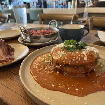 Panxa Cocina - Short rib enchiladas with Christmas sauce and sweet potato breakfast potatoes and a side of bacon - Cocktail Bars Near Me - Long Beach, California Panxa Cocina - Short rib enchiladas with Christmas sauce and sweet potato breakfast potatoes and a side of bacon - Cocktail Bars Near Me - Long Beach, California