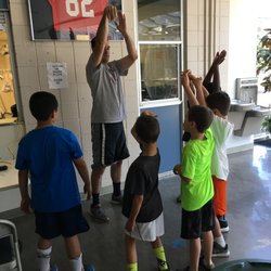 Saratoga Basketball Camp - Coach going over video of the players explaining proper technique