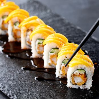 Rock N Roll Sushi - Shrimp tempura, cream cheese and cucumber inside, sliced mango outside, topped with sweet chili and eel sauce. - Sushi Bars Near Me - Ridgeland, Mississippi Rock N Roll Sushi - Shrimp tempura, cream cheese and cucumber inside, sliced mango outside, topped with sweet chili and eel sauce. - Sushi Bars Near Me - Ridgeland, Mississippi