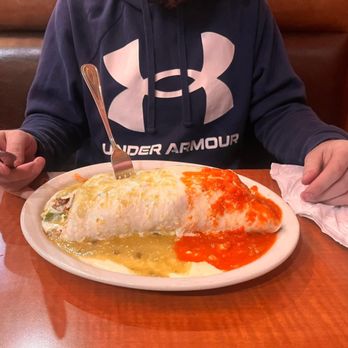 El Camino Real - a man sitting at a table with a plate of food - Mexican Near Me - Wixom, Michigan El Camino Real - a man sitting at a table with a plate of food - Mexican Near Me - Wixom, Michigan