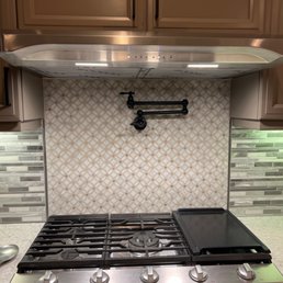 Samsung 5 burner stove top and Broan Elite range.