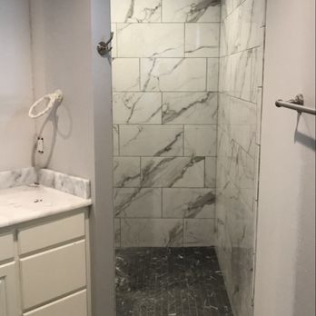 Pin-It Construction - a bathroom with a marble shower - General Contractors Near Me Pin-It Construction - a bathroom with a marble shower - General Contractors Near Me