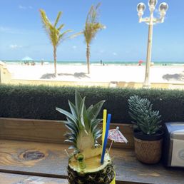 Piña colada mixed with mango daiquiri in a fresh pineapple Piña colada mixed with mango daiquiri in a fresh pineapple