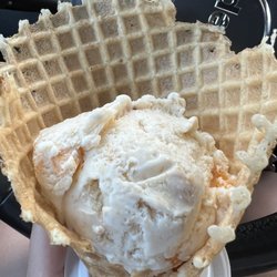 Loaded Cow - Peach ice cream in a waffle cone