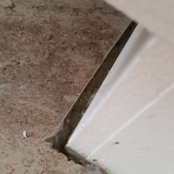 Adair Floors n More - Edge of tile near stove no grout or caulk put in place, open gap left