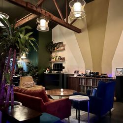 Decibel Sound & Drink - Interior layout. Great lighting.. Mid century vibes. Turntable and vinyl at the ready