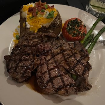 V's Steakhouse - 14oz boneless ribeye, baked potato, roasted tomato and asparagus. - Steakhouses Near Me - Mabank, Texas