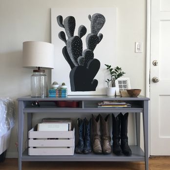 Sims Holland Design - A simple, clean entry table shows off these cowboy boots as well as neatly storing them. - Interior Design Near Me Sims Holland Design - A simple, clean entry table shows off these cowboy boots as well as neatly storing them. - Interior Design Near Me