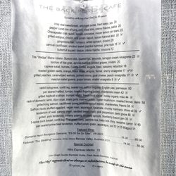 Back Porch Cafe - Menu posted facing sidewalk. March 2025 so before opening for the 2025 season.