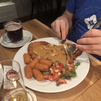 Wurst & Schnitzelhaus - WuSH - Another schnitzel with mushrooms and he chow croquette for the side. The beverage he has is gluewein (hot mulled wine ) - German Near Me - Amsterdam, New Hampshire Wurst & Schnitzelhaus - WuSH - Another schnitzel with mushrooms and he chow croquette for the side. The beverage he has is gluewein (hot mulled wine ) - German Near Me - Amsterdam, New Hampshire