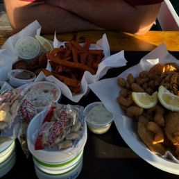 Seafood sampler (fried shrimp, scallops, mussels, haddock), bacon wrapped oysters (fried), clam chowder, coleslaw, sweet potato fries,