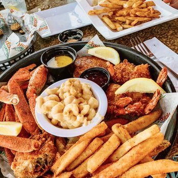 Crabby's Oceanside - Seasoned 3/4lb crab legs w/crispy coconut shrimp, savory crab cake, and baked Mac & cheese. Beach chicken soft tacos. - Seafood Near Me - Daytona Beach, Florida