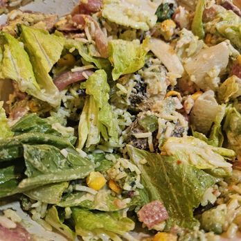 CAVA - Market Spice - A mixed salad with lettuce, shredded cheese, corn, and bits of meat, served in a bowl with a creamy dressing. - Salad Near Me - Moorestown, New Jersey