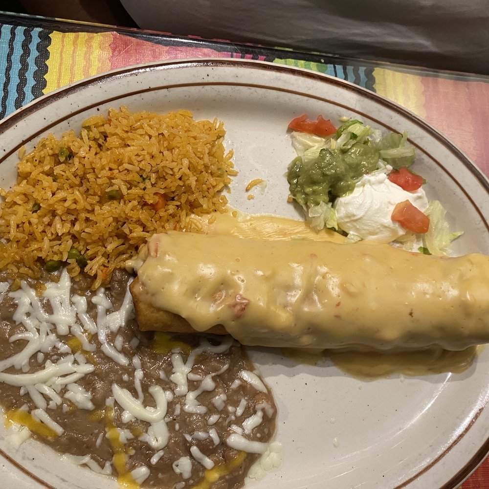Los Chicos - Shredded Chicken Chimichanga topped with Queso Rice and Beans and toppings - Mexican Near Me - Zephyrhills, Florida Los Chicos - Shredded Chicken Chimichanga topped with Queso Rice and Beans and toppings - Mexican Near Me - Zephyrhills, Florida