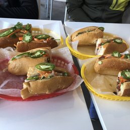 Top left: chicken banh mi Top right: original banh mi Bottom right: pork banh mi Bottom left:vegetarian banh mi