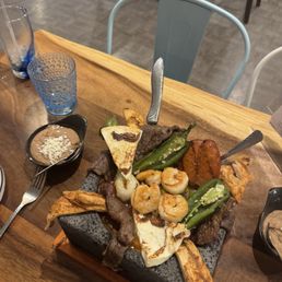 Chicken, prawns, short ribs, and beef accompanied by jalapeño pepper, Mexican cheese, dip sauce and beans. Chicken, prawns, short ribs, and beef accompanied by jalapeño pepper, Mexican cheese, dip sauce and beans.