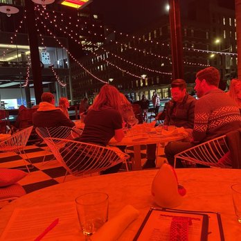 The Standard Plaza - a group of people sitting at a table - New American Near Me - New York, New York The Standard Plaza - a group of people sitting at a table - New American Near Me - New York, New York