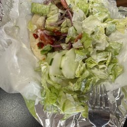 Underneath the iceberg with ranch is 4 pieces of dry Lamb Tikka Wrap
