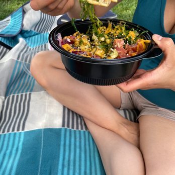 Pacific Poke - a woman eating a bowl of food - Japanese Near Me - Kelowna, British Columbia Pacific Poke - a woman eating a bowl of food - Japanese Near Me - Kelowna, British Columbia