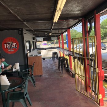 7taco - a man sitting at a table in a restaurant - Tacos Near Me - Houston, Texas