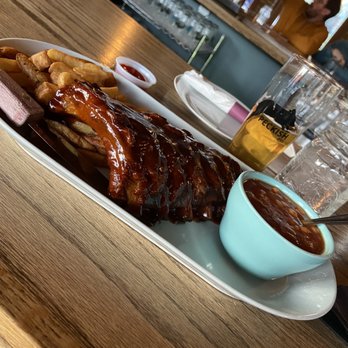Peckish Pig - Half Rack BBQ Ribs with fries and baked beans. Lawless Kölsch I'm the back. - Breakfast & Brunch Near Me - Evanston, Illinois Peckish Pig - Half Rack BBQ Ribs with fries and baked beans. Lawless Kölsch I'm the back. - Breakfast & Brunch Near Me - Evanston, Illinois