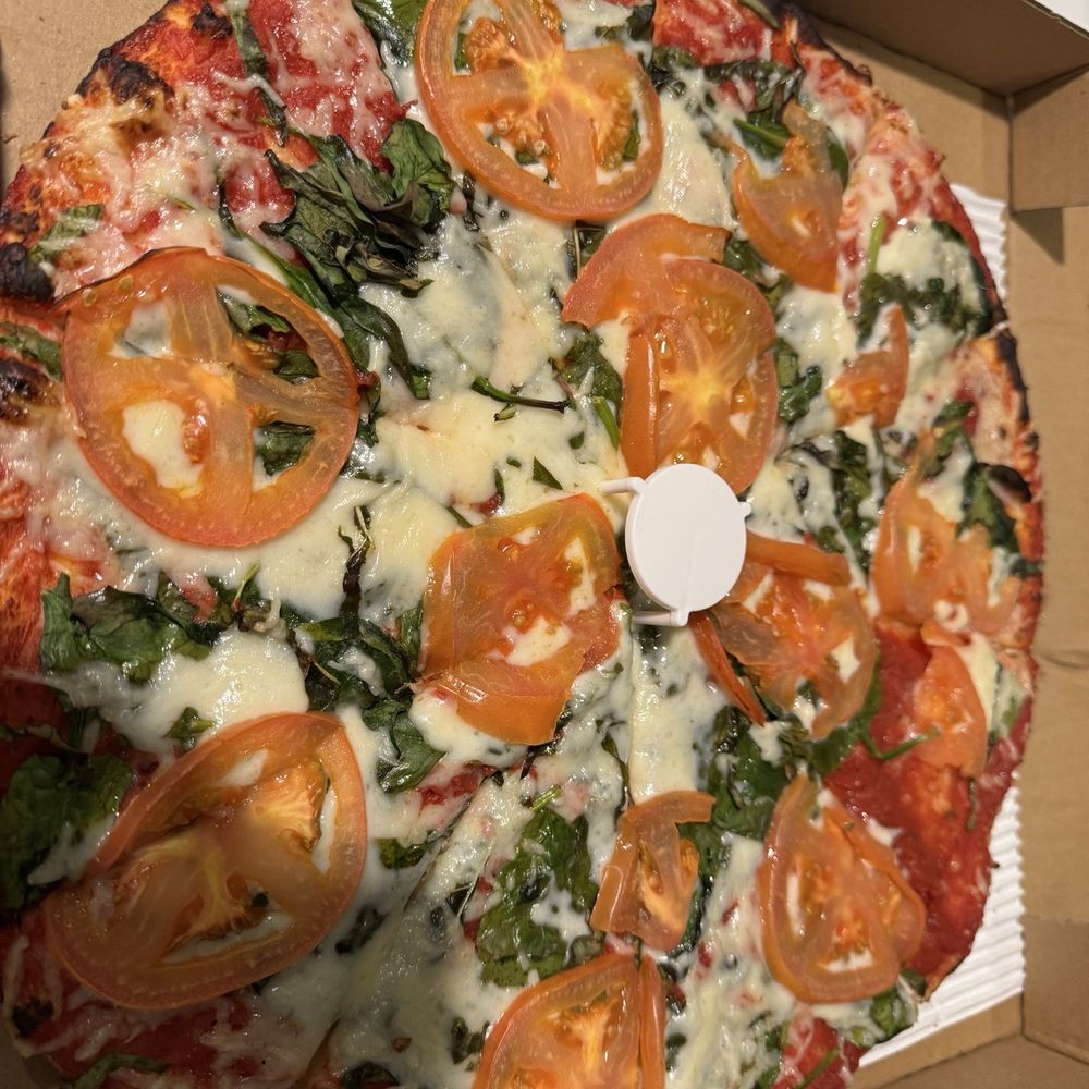 Thin crust pizza with vegan cheese, spinach, basil and tomatoes. Thin crust pizza with vegan cheese, spinach, basil and tomatoes.