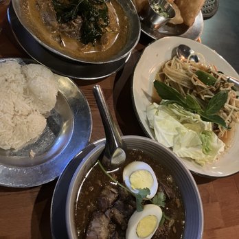 Isarn Thai Soul Kitchen - Clockwise: Lamb Massamun with Roti, Papaya Salad, Phuket Pork Belly Stew, Sticky Rice - Noodles Near Me - Seattle, Washington