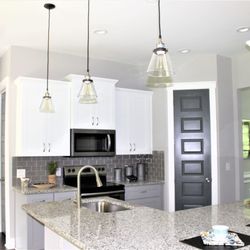 Royal Granite Countertops | Woodstock - Bella White Granite, and Raised Bar Removal to one level. 4 Hour Installation time.