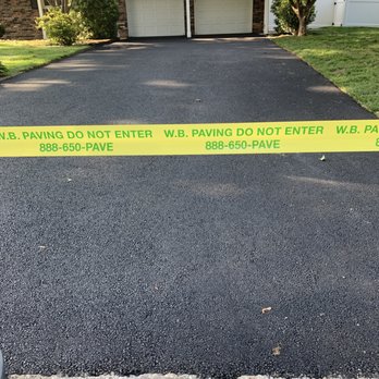 WB Paving - a driveway taped with yellow tape - General Contractors Near Me