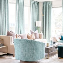 Sweet Design Studio - living room features a serene color palette of seafoam green and dusty rose, with plush velvet seating, floor to ceiling curtains