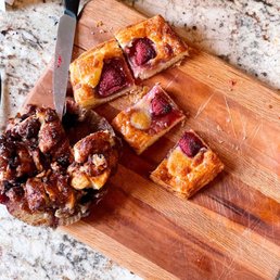 a cutting board with a pastry and a knife a cutting board with a pastry and a knife
