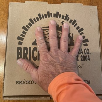 Brick Oven Pizza Company - Medium pizza in comparison to hand - Pizza Near Me - Abilene, Texas