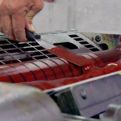 Bayside Printing Company - Pressman loads ink into an offset printing press.