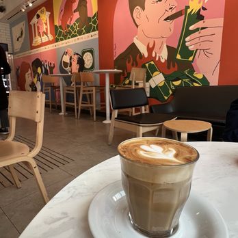 Artigiano - Howe Street - Cortado and murals on the wall of the cafe's interior. - Coffee & Tea Near Me - Vancouver, British Columbia Artigiano - Howe Street - Cortado and murals on the wall of the cafe's interior. - Coffee & Tea Near Me - Vancouver, British Columbia