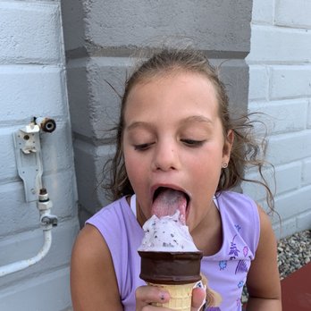 Ice Cream Garage - a young girl eating an ice cream cone - Ice Cream & Frozen Yogurt Near Me - Linden, Michigan Ice Cream Garage - a young girl eating an ice cream cone - Ice Cream & Frozen Yogurt Near Me - Linden, Michigan