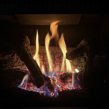 True Pros - Yep! Toasty warm and ready for crisp, cool autumn evenings... - A fireplace with burning logs and visible flames, creating a warm atmosphere. - Heating & Air Conditioning/HVAC Near Me - Ogden, Utah