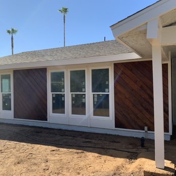Fairview Paint - Front of the house showing refinished cedar siding with newly painted white trim on posts, beams, frames and fascia - Painters Near Me - Rialto, California