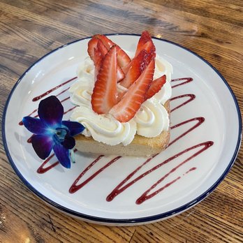 Sugar Milk Cafe - Trés Leche with a strawberry drizzle and fresh berries and garnished with this stunning orchid - Breakfast & Brunch Near Me - Naperville, Illinois Sugar Milk Cafe - Trés Leche with a strawberry drizzle and fresh berries and garnished with this stunning orchid - Breakfast & Brunch Near Me - Naperville, Illinois