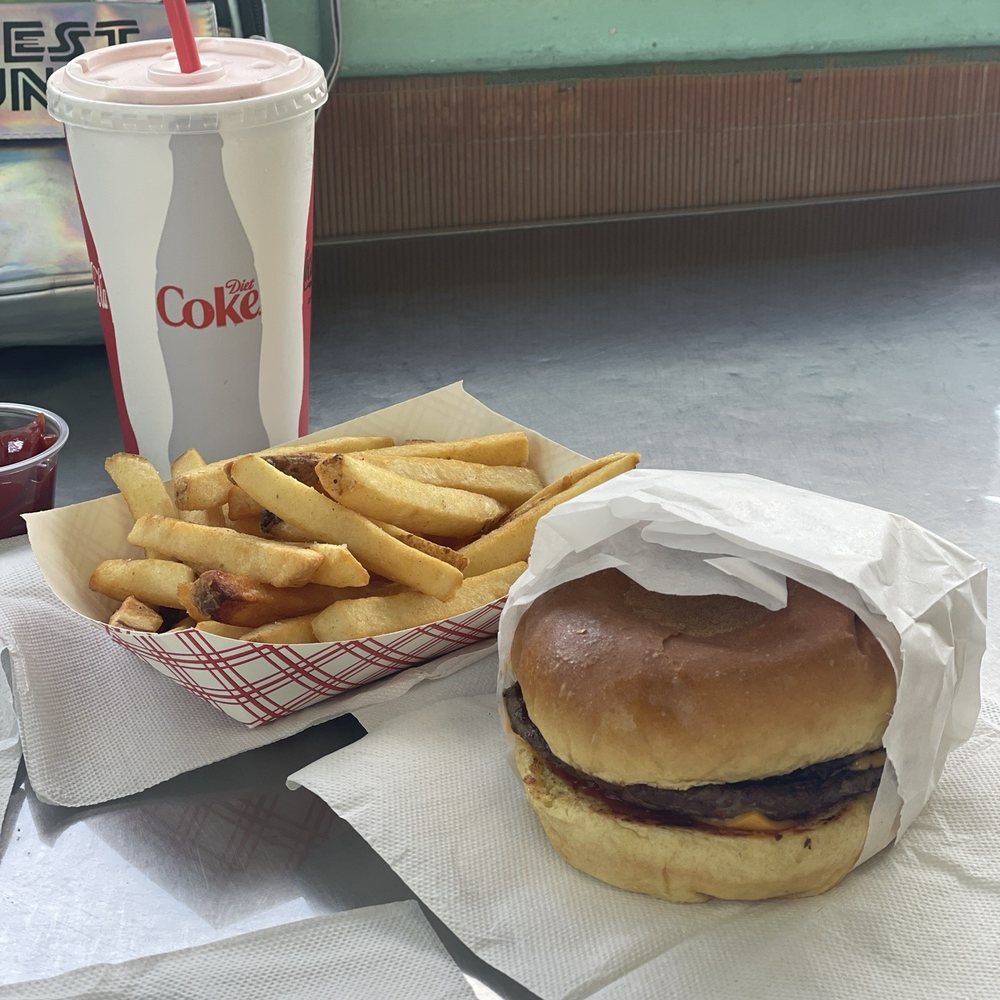 Cheeseburger, fries and strawberry milkshake. Cheeseburger, fries and strawberry milkshake.