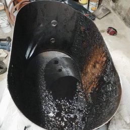 Old tank, cut open and ready to be removed. Old tank, cut open and ready to be removed.