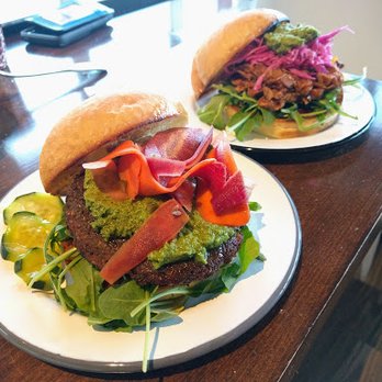 Veg Kitchen + Bar - Falafel burger (front dish in picture with green pesto) and sloppy jack (back). - Vegan Near Me - Sacramento, California Veg Kitchen + Bar - Falafel burger (front dish in picture with green pesto) and sloppy jack (back). - Vegan Near Me - Sacramento, California