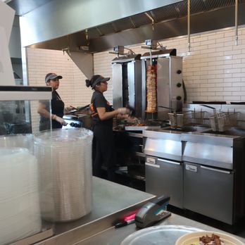 Naf Naf Grill - Staffers in the open kitchen. - Middle Eastern Near Me - Lincolnshire, Illinois