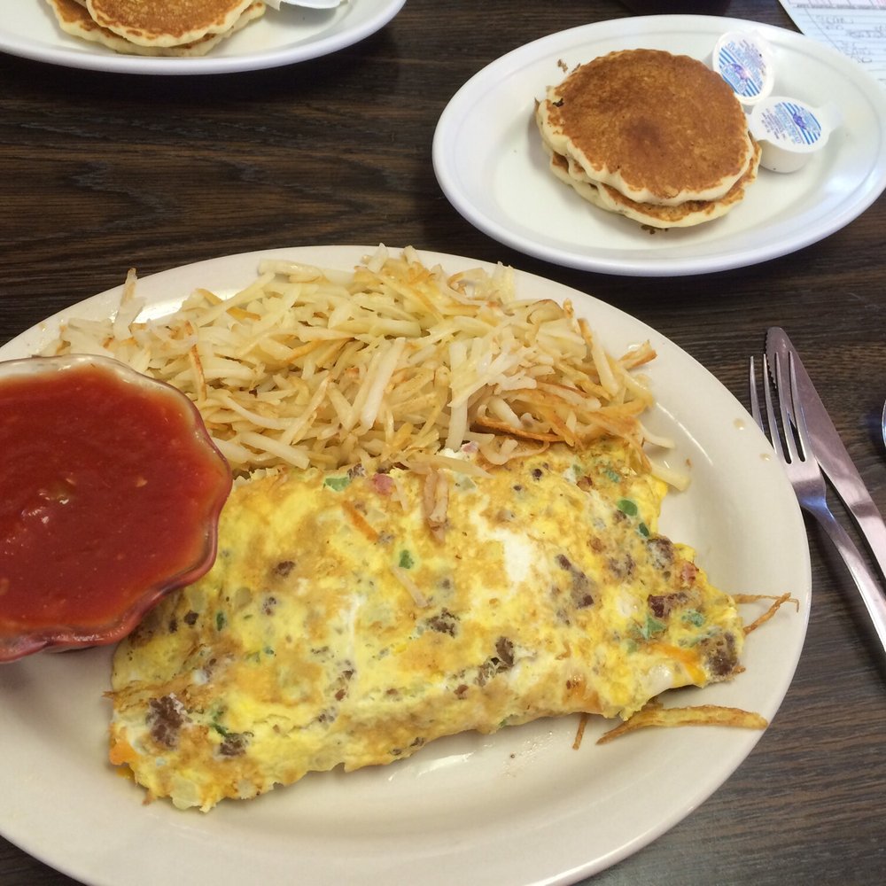 an omelet, hash browns, and pancakes an omelet, hash browns, and pancakes